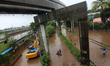 People wade through a flooded road during heavy rains in Mumbai, India on August 04, 2020....