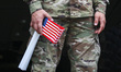 An American soldier is seen with U.S. flag during a ceremony at the Kosciuszko Mound in Kr...