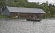 Villagers ride on a boat through flood water at Manikganj near Dhaka, Bangladesh, on Augus...