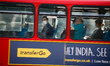 Passengers wearing face masks ride a bus through Bank Junction in the City of London finan...