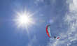 A paragliding athlete flying with the Indonesian flag. This is done to commemorate Indones...