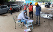 A health worker registers a patient before nasal swab sample collection for Covid-19 rapid...