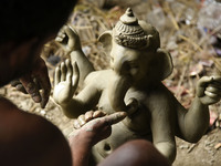Artisans working on making an idol of elephant headed Hindu god Ganesha at a workshop ahead of the Ganesh Chaturthi festival, in Guwahati, A...