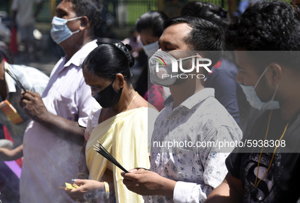 Devotees visit a Ganesh Temple wearing mask on the occasion of Ganesh Chaturthi, amid the ongoing coronavirus pandemic, in Guwahati, Assam,...