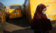 A women wears a mask as she going to her workplace in a early morning in Dhaka , Banglades...