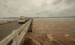Flood waters of Mahanadi river flows downwards after barrage gates open at Mundali outskir...