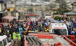 Crowd gather amidst debris of a Quorom helicopter crash, a helicopter operated by Quorom A...
