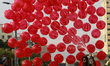 A vendor selling balloons looks for customers along a street amid the coronavirus pandemic...