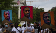 Protestors march with George Floyd signs during the 57th annual March on Washington, Frida...