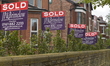 Light shining on 'Sold' signs outside a residency in Manchester on Tuesday 19th May 2015....