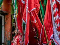 Women watches the preparation of the muharram celebration from the house inside the geneva camp in Dhaka, Bangladesh, on August 29, 2020.  (