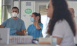 Healthcare workers resting as they roate shifts during the testing. Travelers in cars and...