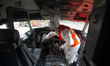 A worker with a biohazard suit disinfects and cleans the cockpit of the planes before boar...