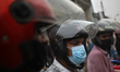 Motorcycle riders wait for passengers beside a street in Dhaka, Bangladesh, September 01 ,...