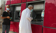 Palestinian employees receiving their wages via an ATM outside a bank of Palestine amid th...
