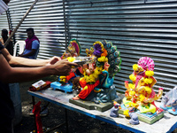 A Hindu devotees seen praying to idol of elephant-headed Hindu God Ganesh on the last day of the Ganesh Chaturthi festival in Nagpur, India,...
