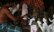 An artist works on a clay idol of the Hindu Goddess ahead of Durga Puja festival in Dhaka,...
