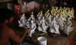 An artist works on a clay idol of the Hindu Goddess ahead of Durga Puja festival in Dhaka,...