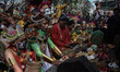 

Ritual participants display masks and pray at the tomb area of the creator of the Mala...