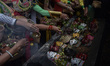 
Ritual participants display masks and pray at the tomb area of the creator of the Malang...
