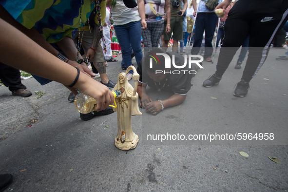 Devotees of Santa Muerte attend to ask for a command and ask her for a favor, so kneeling, with flowers and candles, they arrive at her alta...