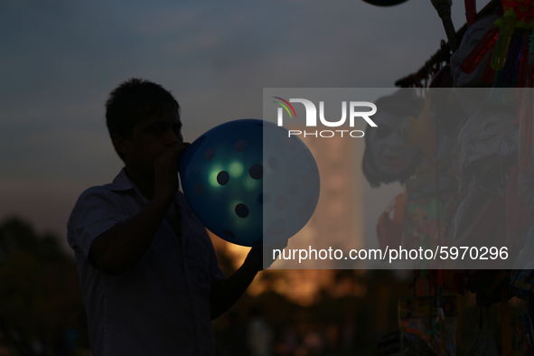 A street hawker blowing balloon at a park in Dhaka, Bangladesh on September 4, 2020.  