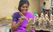 Tamil woman painting small clay idols of Lord Ganesha (Lord Ganesh) at an idol workshop al...