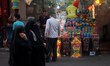 A Palestinian vendor sets up traditional Ramadan lanterns in a street market in Gaza City,...