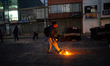 A demonstratos throws a molotov cocktail during a protest against the death of a lawyer un...