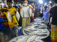 Bangladeshi vendors show Hilsa fish for sell at the Karwan Bazar wholesale fish market in Dhaka, Bangladesh, on September 10, 2020. (