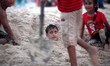 Palestinians are seen at the beach as the sun sets during a summer's day in Gaza City, on...