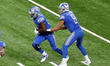 Detroit Lions quarterback Matthew Stafford (9) hands off the ball to Detroit Lions running...