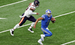 Detroit Lions quarterback Matthew Stafford (9) runs the ball during the first half of an N...