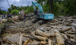Residents witnessed heavy equipment cleaning wood and mud material that had piled up roads...