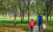 Father with son walks in front of the group of 112 figures, titled Unrecognized (Nierozpoz...