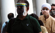 Commuter wearing faceshield as a preventive measure against the Covid-19 coronavirus wait...