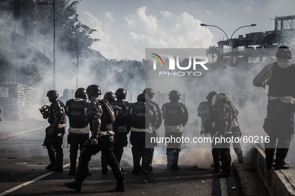 Bolivarian National Police anti riot squad shooting teargas bombs, in Caracas, Venezuela, on March 20, 2014. 