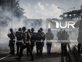 Bolivarian National Police anti riot squad shooting teargas bombs, in Caracas, Venezuela, on March 20, 2014. (