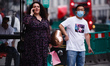 A man wearing a face mask waits at a bus stop on Regent Street in London, England, on Sept...