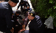 Police officers attend to an injured anti-government protester inside the parliament after...