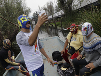 Members of Chinampaluchas aboard a boat, prior to the wrestling function in chinampas of Lake Xochimilco during the health emergency due to...