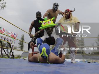 Members of Chinampaluchas, during a wrestling function, fight against the coronavirus in chinampa on Lake Xochimilco during the health emerg...