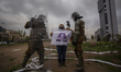 An older adult woman holds a flag with a symbol referring to the "Apruebo" 
(I approve of...