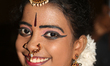 Tamil girl dressed in traditional attire waits to perform a Bharathnatyam dance during a s...