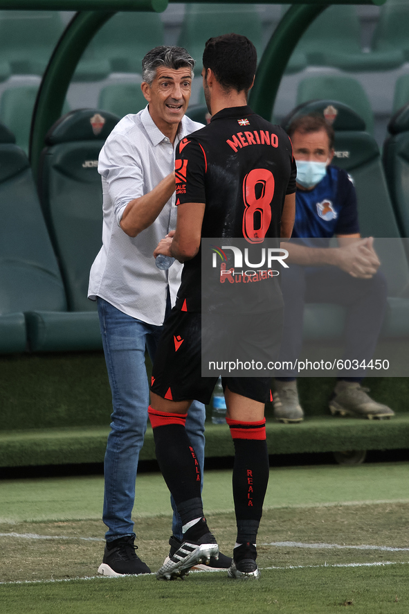 Imanol Alguacil head coach of Real Sociedad gives instructions to Mikel Merino during the La Liga Santader match between Elche CF and Real S...