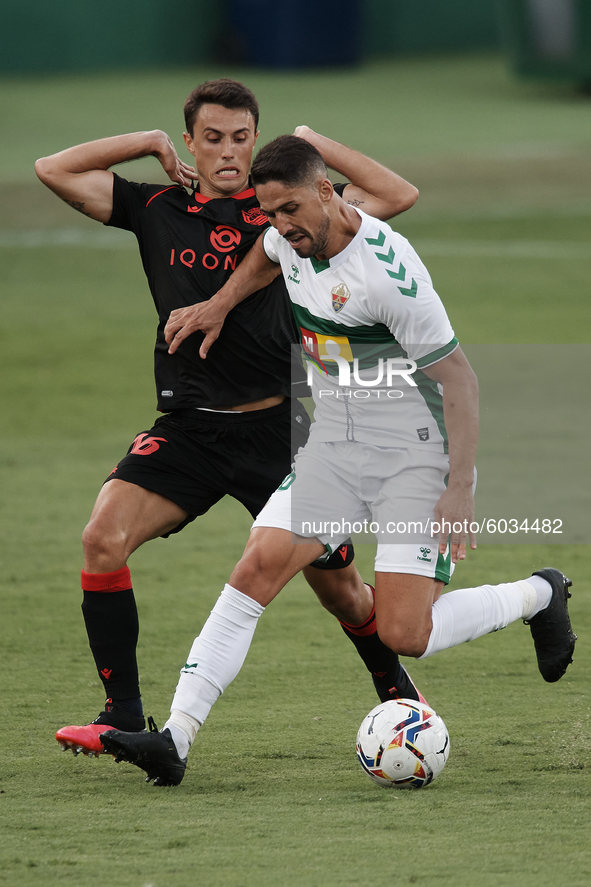 Fidel of Elche and Ander Guevara of Real Sociedad compete for the ball during the La Liga Santader match between Elche CF and Real Sociedad...