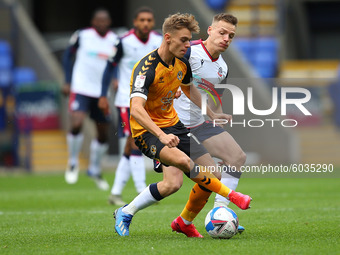   Newports Scott Twine battles with BoltonsTom White during the Sky Bet League 2 match between Bolton Wanderers and Newport County at the Re...
