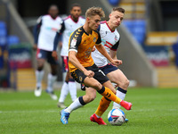   Newports Scott Twine battles with BoltonsTom White during the Sky Bet League 2 match between Bolton Wanderers and Newport County at the Re...