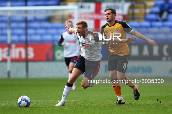   Boltons Eoin Doyle clashes with Matty Dolan during the Sky Bet League 2 match between Bolton Wanderers and Newport County at the Reebok St...