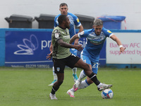   Callum Harriott of Colchester United in action with Bradley Barry    during the Sky Bet League 2 match between Barrow and Colchester Unite...